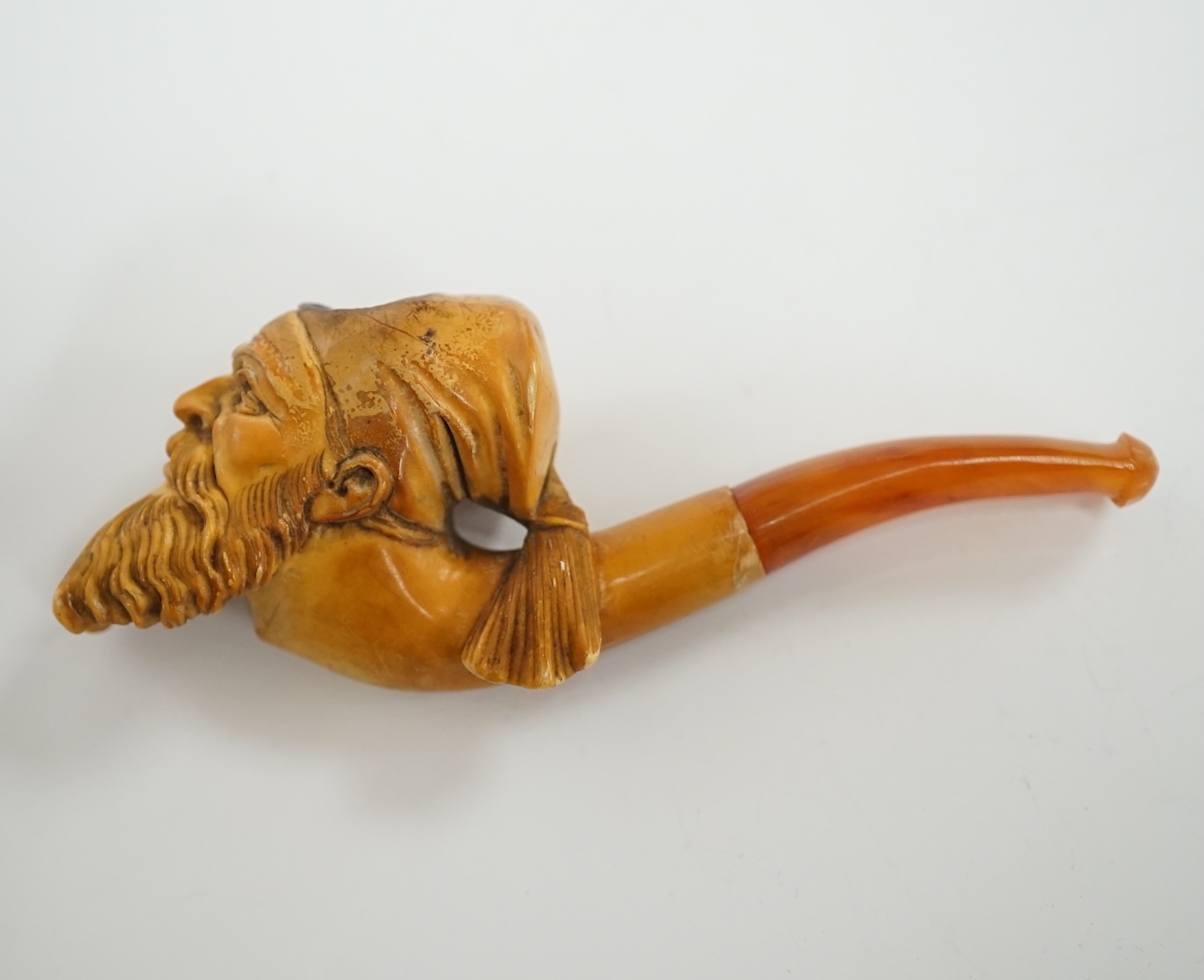 A small group of collectables including a cased Meerschaum pipe, a Dunhill lighter, a yellow metal mounted nephrite pendant, 53mm, yellow metal mounted amber cigarette holder in a silver case, Eloga wrist watch, etc. Con